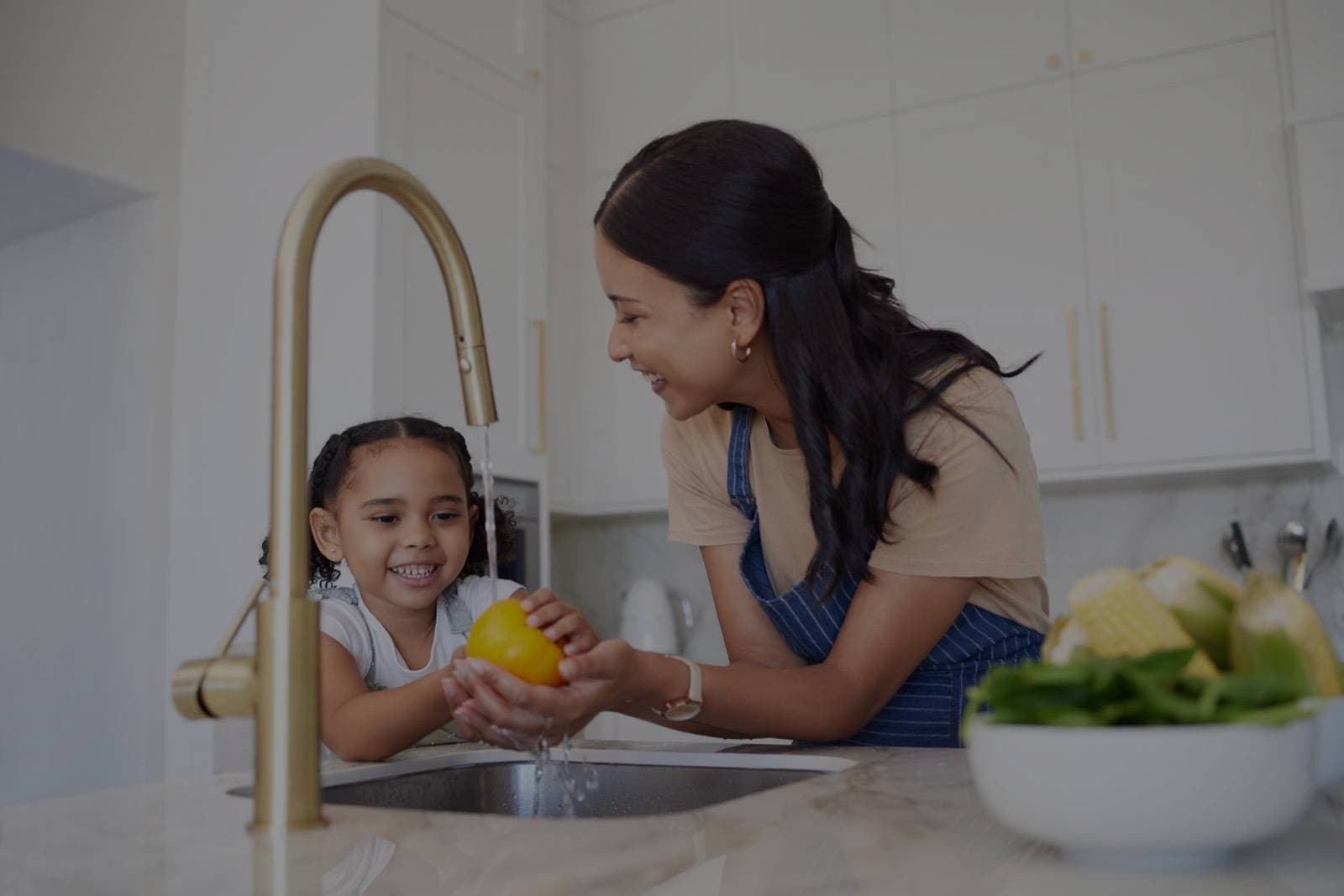 Family enjoying soft water at the kitchen sink