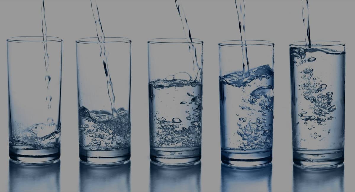 Row of glasses being filled with pure filtered water
